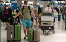  ?? MARTA LAVANDIER — THE ASSOCIATED PRESS ?? A family and their pets walk through Miami Internatio­nal Airport on Monday, in Miami.