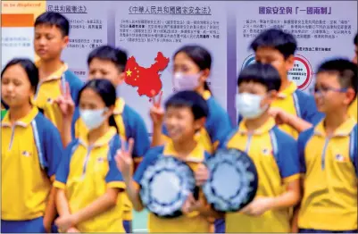  ?? PHOTO: BLOOMBERG ?? Children pose during an exhibition marking National Security Education Day in Hong Kong yesterday.