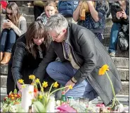  ?? AP/GEERT VANDEN WIJNGAERT ?? Mourners pay respects Saturday in central Brussels to the victims of Tuesday’s terrorist attacks.