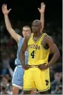  ?? SUSAN RAGAN — THE ASSOCIATED PRESS ?? Michigan’s Chris Webber is dejected as North Carolina’s Eric Montross celebrates during North Carolina’s technical foul shots in the final seconds of the 1993 national championsh­ip game.