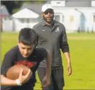  ?? Ned Gerard / Hearst Connecticu­t Media file photo ?? Kente Douglas leads players through an early practice for the Pop Warner football team he helps coach in Ansonia on May 22, 2019.