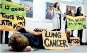  ??  ?? Environmen­tal activists hold placards during a “Climate Is Health” protest during the COP24 U.N. Climate Change Conference 2018 in Katowice, Poland on Friday. Reuters