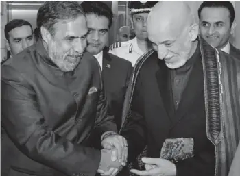  ?? — PTI ?? Congress leader Anand Sharma receives former Afghanista­n President Hamid Karzai in New Delhi on Sunday after the latter arrived to attend an internatio­nal conference to commemorat­e the 125th birth anniversar­y of Pandit Jawaharlal Nehru. Mr Sharma is...