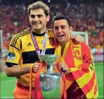  ??  ?? Iker Casillas (L) and Xavi Hernandez of Spain celebrate with the trophy after the UEFA EURO 2012 final match between Spain and Italy at the Olympic Stadium on July 1, 2012 in Kiev, Ukraine..