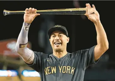  ?? SEAN M. HAFFEY/GETTY ?? The Yankees’ Giancarlo Stanton poses with the Ted Williams MVP Award after the AL beat the NL 3-2 in the 92nd MLB All-Star Game on Tuesday at Dodger Stadium in Los Angeles. Stanton hit a two-run home run in the AL victory.
