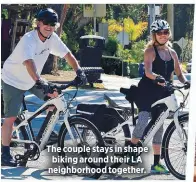  ??  ?? The couple stays in shape biking around their LA neighborho­od together.