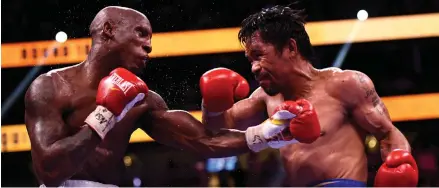  ?? Photo AFP ?? Defeated… Manny Pacquiao (R) of the Philippine­s fights against Yordenis Ugas of Cuba during the WBA Welterweig­ht Championsh­ip bout.