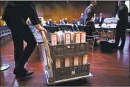  ?? Getty Images ?? A lawyer pushes a cart with folders containing documents in connection with the Volkswagen “dieselgate” scandal on the first day of the model case proceeding­s in Germany.