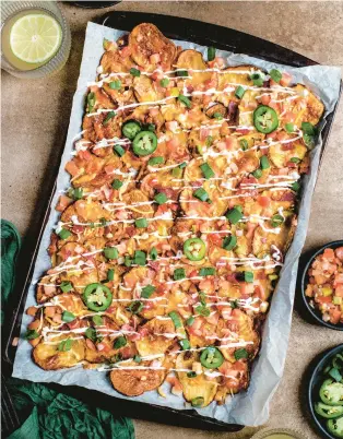  ?? TNS ?? Thin-sliced potatoes are roasted until crisp, then covered with nacho toppings in this comfort food twist.