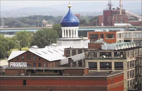  ?? Bob Child / Associated Press ?? In this July 22, 2008, file photo, the blue dome of the former Colt firearms factory sits atop the Coltsville complex in Hartford. The 179- year- old gunmaker filed for Chapter 11 bankruptcy in 2015, estimating it owes up to $ 500 million. Analysts...