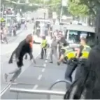  ??  ?? ATTACK UNDERWAY: A video grab shows Hassan Khalif Shire Ali fighting with policemen in Melbourne.