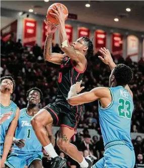  ?? Brett Coomer/Houston Chronicle ?? Houston guard Marcus Sasser takes the ball to the basket against Tulane during the first half on Wednesday in Houston.