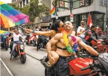  ?? Gabrielle Lurie / The Chronicle 2019 ?? Amy Dabner embraces Adam Schindler at last year’s Gay Pride Parade. This year’s festival will be staged online.