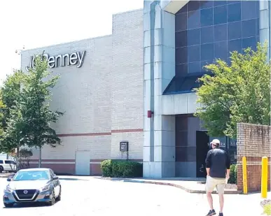  ?? STAFF PHOTO BY MIKE PARE ?? A shopper at Hamilton Place mall walks by the closed JCPenney store on Monday. The store is slated to reopen Wednesday.