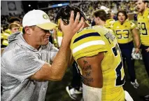  ?? DANIEL VARNADO / AP ?? Georgia Tech interim head coach Brent Key celebrates with defensive back Clayton Powell-lee (right) after defeating Duke 2320 in overtime on Saturday in Atlanta.