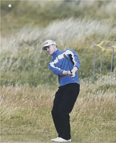  ??  ?? Connor Syme plays his chip shot to the 13th following his debilitati­ng quadruple bogey at the 12th.