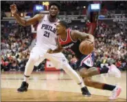  ?? NICK WASS - THE ASSOCIATED PRESS ?? Washington Wizards guard Bradley Beal (3) drives to the basket against Philadelph­ia 76ers center Joel Embiid (21) during the second half of an NBA game, Sunday, in Washington.