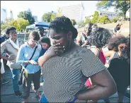  ?? AP/The Charlotte Observer/JEFF SINER ?? Protesters listen Saturday to Charlotte Police Chief Kerr Putney’s announceme­nt about the release of portions of video showing a police officer’s fatal shooting of Keith Lamont Scott in Charlotte, N.C.