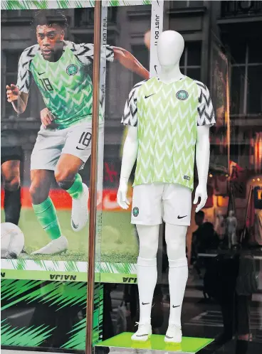  ??  ?? The bright Nike-made Nigerian national soccer team jerseys are a hit with World Cup fans, selling out in many areas almost immediatel­y. — photos: The Associated Press