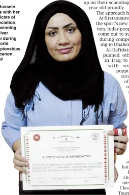  ??  ?? Alia Hussein poses with her certificat­e of appreciati­on, after winning the silver medal during the world championsh­ips in Lebanon. — AFP