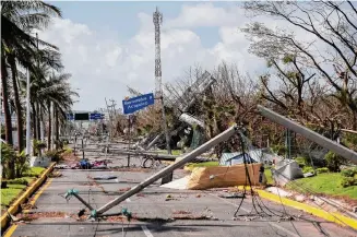  ?? Felix Marquez/Associated Press ?? Crews clear streets Saturday in Acapulco as motorists lined up for fuel and a more organized relief operation took shape four days after Hurricane Otis made landfall as a Category 5 storm.