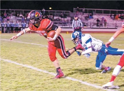  ?? GABRIELA CAMPOS/NEW MEXICAN FILE PHOTO ?? Las Vegas Robertson’s Santiago Gonzales pushes through St. Michael’s defenders during an Oct. 20 game in Las Vegas, N.M. Robertson faces Ruidoso on Saturday in the Class 4A state championsh­ip game.