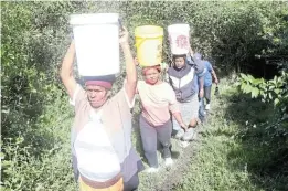  ?? Pictures: SIKHO NTSHOBANE ?? STRUGGLE: Due to water shortages villagers in Port St Johns have to wake-up at the crack of dawn to fetch the precious liquid from dirty natural ponds.