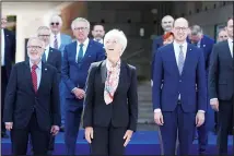  ??  ?? President of the European Investment Bank Werner Hoyer, (left), and European Central Bank President Christine Lagarde, (center), look up during a group photo of EU finance ministers and central bankers during a meeting in Lisbon, May 21, 2021. (AP)