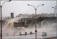  ?? (AP/Matilde Campodonic­o) ?? Waves crash over the sea wall Tuesday in Montevideo, Uruguay.