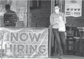  ?? LM OTERO/ AP ?? A customer wears a face mask as he carries an order in September at an eatery in Richardson, Texas.