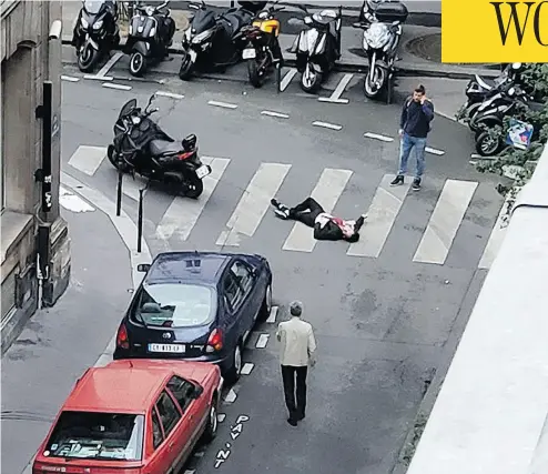  ?? WLADIA DRUMMOND VIA THE ASSOCIATED PRESS ?? A man lays on a street in central Paris Saturday after a stabbing rampage by a 20-year-old Chechen-born man, who was fatally shot by police. The killer was on a police watchlist for radicalism but had a clean criminal record.