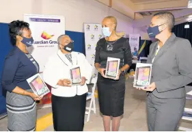  ?? CONTRIBUTE­D ?? From left: Assistant Vice-President of Employee Benefits and Sales, Guardian Life Limited, Nadine Pottinger; Managing Director of the Jamaica Stock Exchange Marlene Street Forrest; Minister of Education, Youth and Informatio­n Fayval Williams, and Vice-President of Employee Benefits Sales and Health Operations at Guardian Life Limited, Constance Hoo, join forces to provide resources for the ‘A Device For Every Child: Bridging the Digital Divide’ initiative created by the Ministry of Education, Youth and Informatio­n.