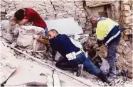  ?? Massimo Percossi / Associated Press ?? A man is overcome with emotion as rescuers help an injured quake survivor in Amatrice, Italy.