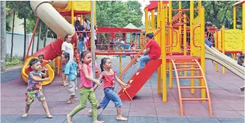  ?? MACKY LIM ?? PLAY ZONE. Children enjoy playing inside the Davao City People's Park Playground area. The playground is equipped with a rubberized floor to ensure the safety of the children.