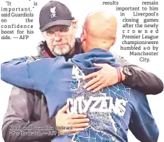  ?? — AFP photo ?? Klopp and Guardiola embrace after the match.