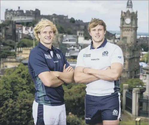  ??  ?? Tartan special: Richie Gray and brother Jonny model Scotland’s new kit which the national side will wear for the first time in their opening match of the World Cup against Japan on 23 September. The jersey includes tartan trim, with the Scottish Rugby...