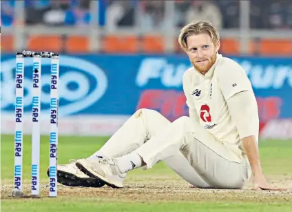  ??  ?? Out of sorts: Ben Stokes sits dejected on the turf during his short spell of three overs