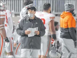  ?? Barry Reeger The Associated Press ?? Ohio State coach Ryan Day looks at the scoreboard during a game Oct. 31 against Penn State. This year’s Ohio State-michigan game has been called off.