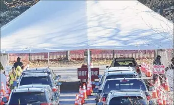  ?? Lori Van Buren / Times Union ?? Vehicles line up at the COVID-19 testing site at the University at Albany. Hospitals say they are prepared for a surge in coronaviru­s cases but warn they don’t have infinite capacity.