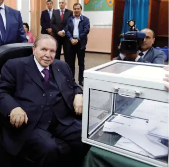  ?? (Zohra Bensemra/Reuters) ?? ALGERIA'S PRESIDENT Abdelaziz Bouteflika looks at journalist­s after casting his ballot during the parliament­ary election in Algiers in May.