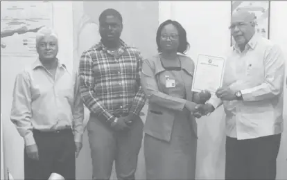  ??  ?? From right are GWI Managing Director Dr. Richard Van West-Charles receiving the certificat­e from the Guyana National Bureau of Standards (GNBS) Head of Conformity Assessment Department Rodlyn Semple while Water Quality Manager Deon Anderson (second from left) and Laboratory Consultant Dr. Karamchand Ramoutar look on.