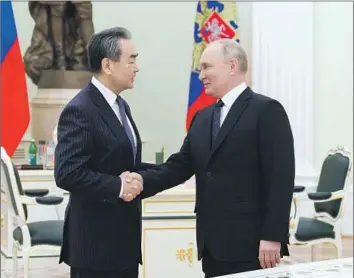  ?? Anton Novoderezh­kin Sputnik ?? WANG YI, the Chinese Communist Party’s most senior foreign policy official, meets with Russian President Vladimir Putin on Wednesday in Moscow, where Putin hailed the two countries’ warm relations.