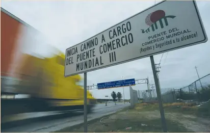  ?? (Daniel Becerril/Reuters) ?? TRUCKS PASS through border customs control before crossing into the US at the World Trade Bridge in Nuevo Laredo, Mexico, on Saturday. The White House has floated the idea of imposing a 20% tax on goods from Mexico to pay for the border wall, sending...