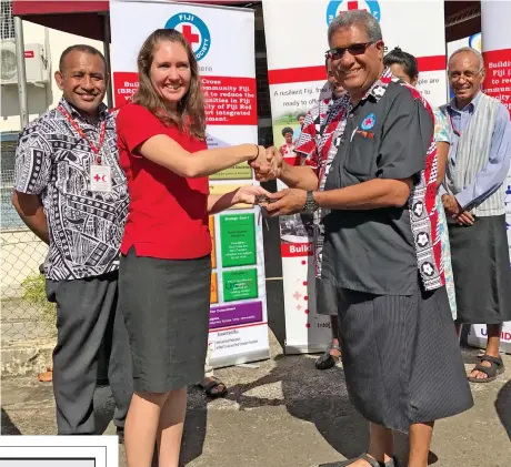  ?? Photo: Ashna Kumar ?? Head of Internatio­nal Federation of Red Cross official Kathryn Clarkson (second from left), hands over the keys for the two new vehicles to Fiji Red Cross Society director general Filipe Nainoca on August 4, 2017.