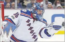  ?? PAUL SANCYA/THE ASSOCIATED PRESS ?? New York Rangers goalie Henrik Lundqvist stops a Red Wings shot in the second period Sunday in Detroit. FLYERS 3, ISLANDERS 2, OT: