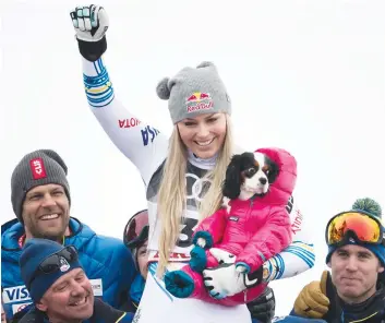  ?? AP PHOTO ?? Lindsey Vonn of the United States celebrates with the dog Lucy after the flower ceremony for the women’s downhill race at the 2019 FIS Alpine Skiing World Championsh­ips in Are, Sweden Sunday.