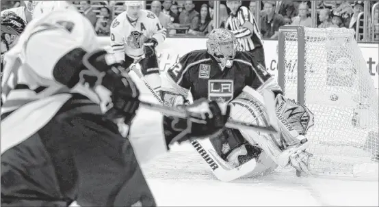  ??  ?? Patrick Kane (foreground) scores the Hawks’ first goal of the season Saturday, beating Kings goalie Jonathan Quick less than four minutes into the game.
| AP