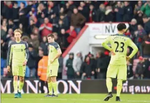  ?? GLYN KIRK/AFP ?? Liverpool’s Lucas Leiva (left), James Milner and Emre Can (right) react after losing 4-3 to Bournemout­h in the Premier League on Sunday night.