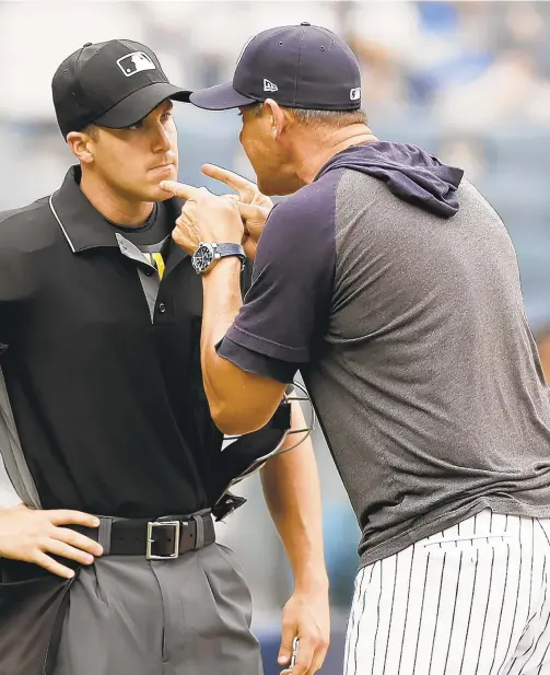  ?? AP ?? Aaron Boone points and yells at umpire Brennan Miller during second inning of first game of doublehead­er against Rays on Thursday. Boone had already been ejected when he expressed his displeasur­e with umpire's calls.