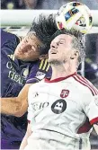  ?? THE ASSOCIATED PRESS ?? Toronto FC defender Kevin Long, right, and Orlando City defender Rodrigo Schlegel compete for a header in the second half Saturday.